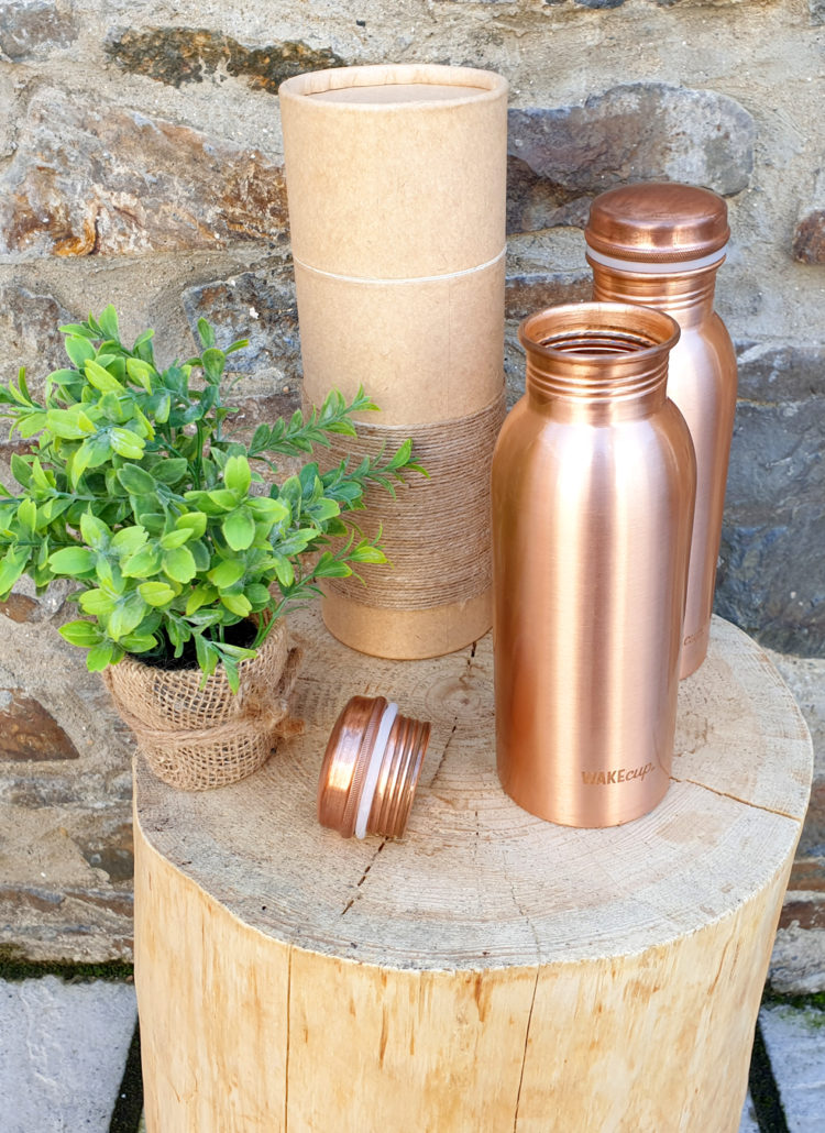 Copper Bottles on Wooden Log