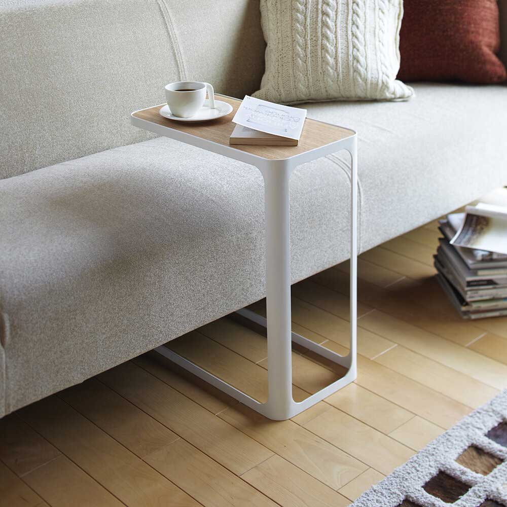 Grey sofa with white and wood C-table
