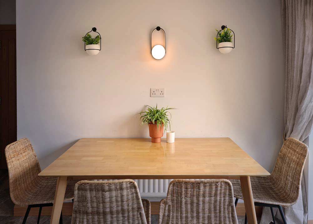 Dining Table with wall planters and wall lamp